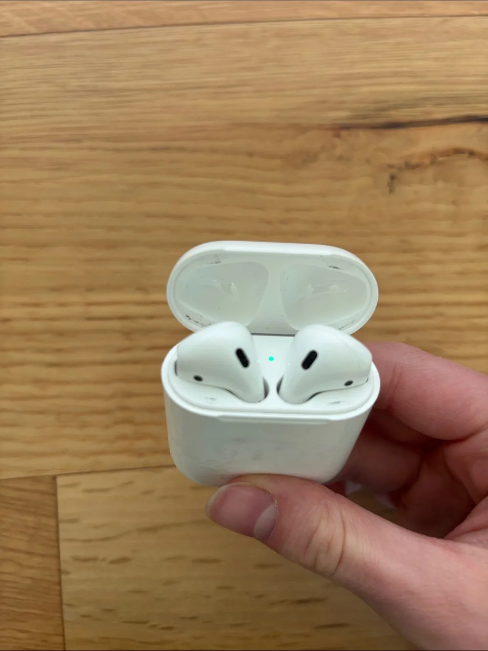 Apple AirPods (2nd gen) with charging case, charging cable, and ThredUp case